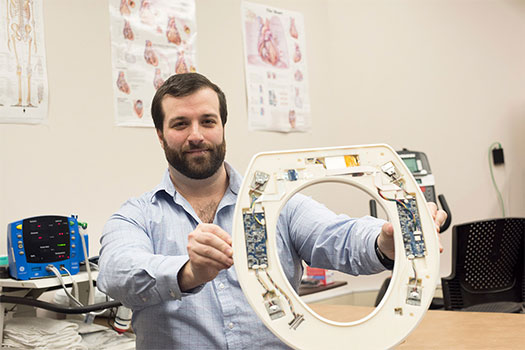 Nicholas Conn, a postdoctoral fellow at RIT and founder and CEO of Heart Health Intelligence, is part of the university team that has developed a toilet-seat based cardiovascular monitoring system.