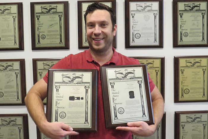 Jesse Dlugos holding his patents